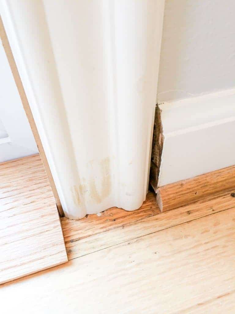 improperly installed door trim with awkward baseboard transition