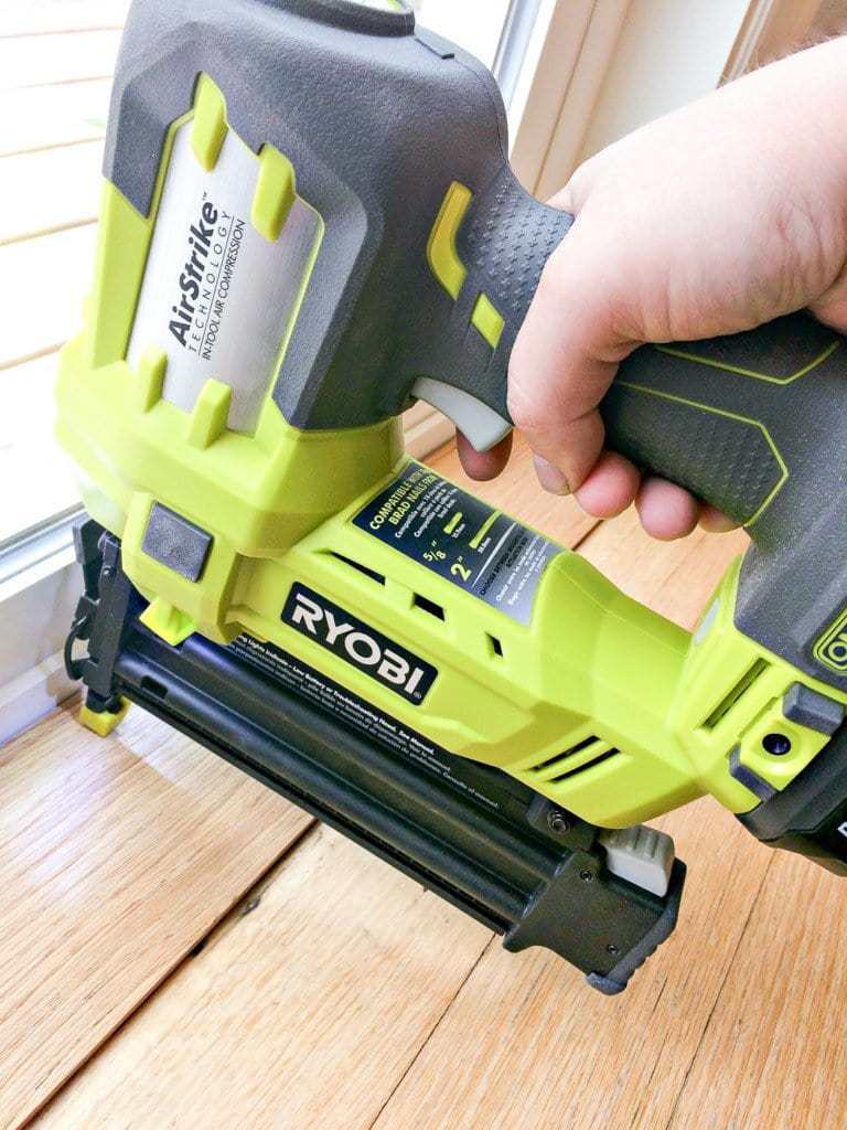 Nailing down the threshold with a cordless brad nailer