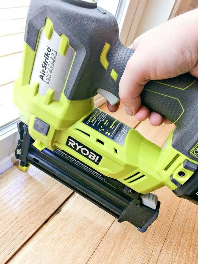 Nailing down the threshold with a cordless brad nailer