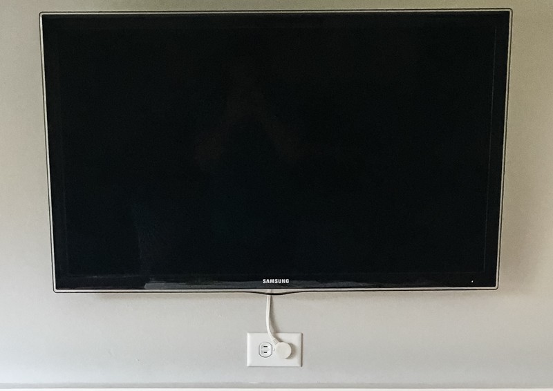 wall mounted TV with Apple TV mount hidden behind