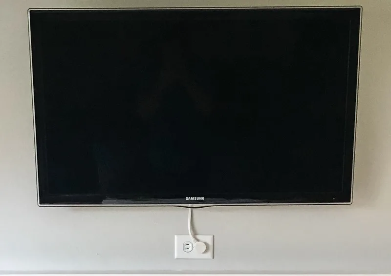 wall mounted TV with Apple TV mount hidden behind