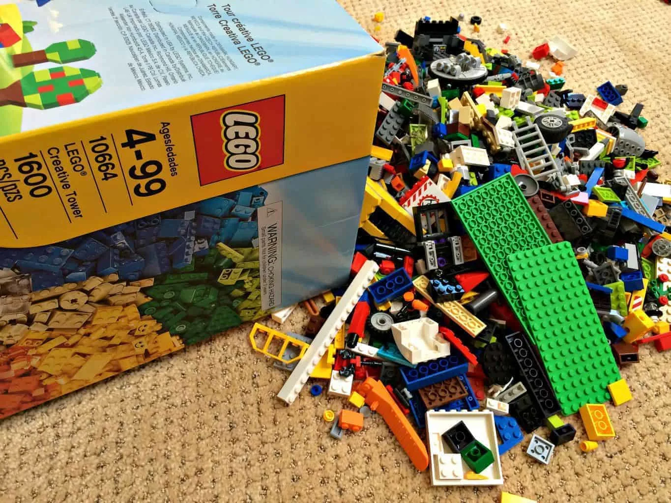 lego pieces dumped on floor from large box