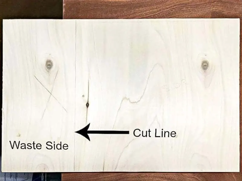 plywood sheet with cut line and waste side marked