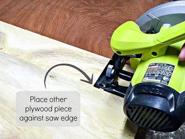 To create the fence for your circular saw jig, line up the other piece of plywood against the circular saw base.