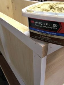 apply wood filler to all the cracks and holes