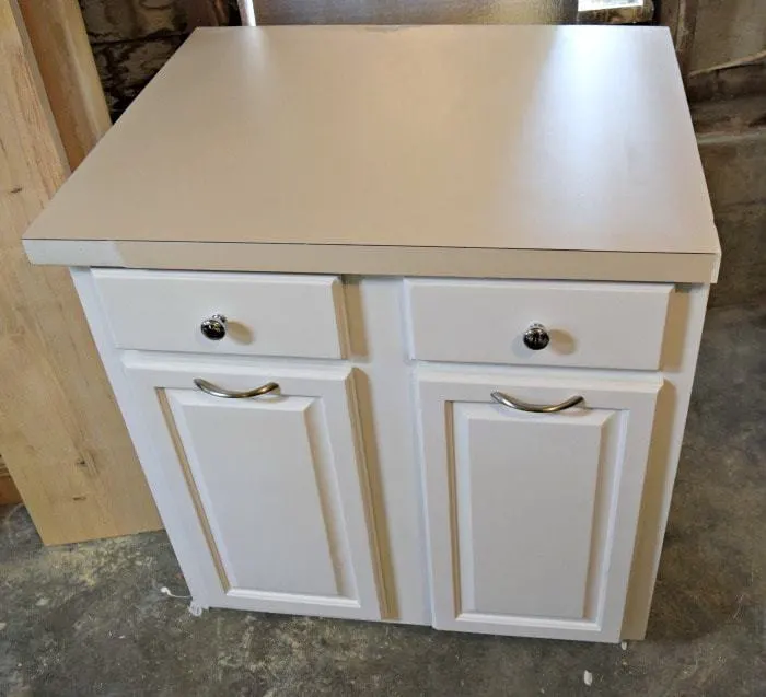 Salvaged kitchen cabinet with damaged laminate countertop