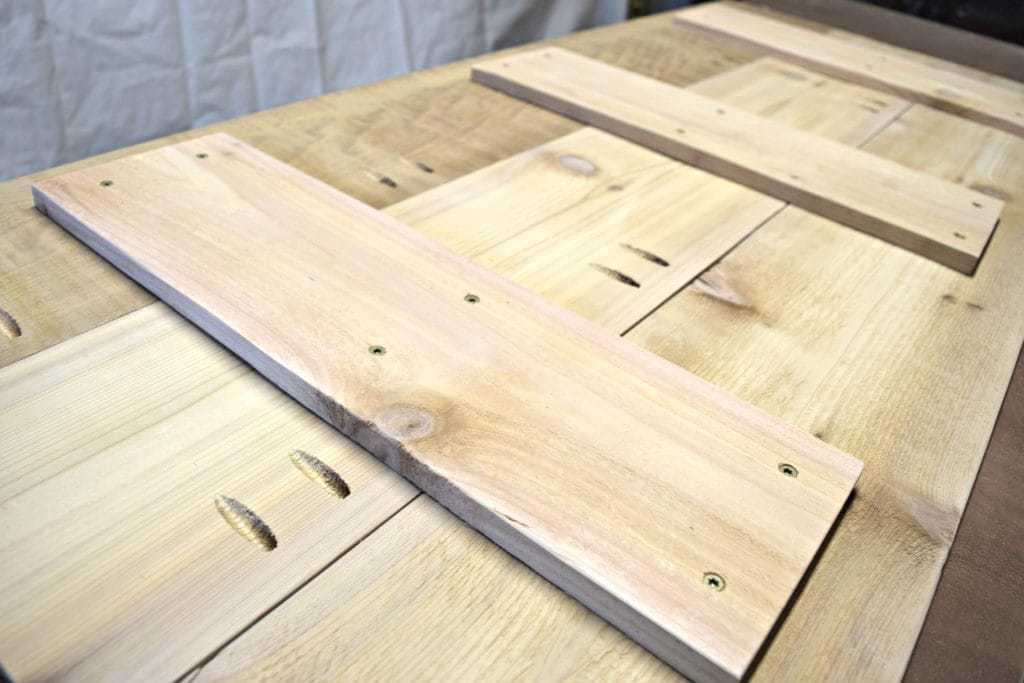 Screw cross support boards to the underside of the outdoor storage bench lid for additional stability - www.thehandymansdaughter.com