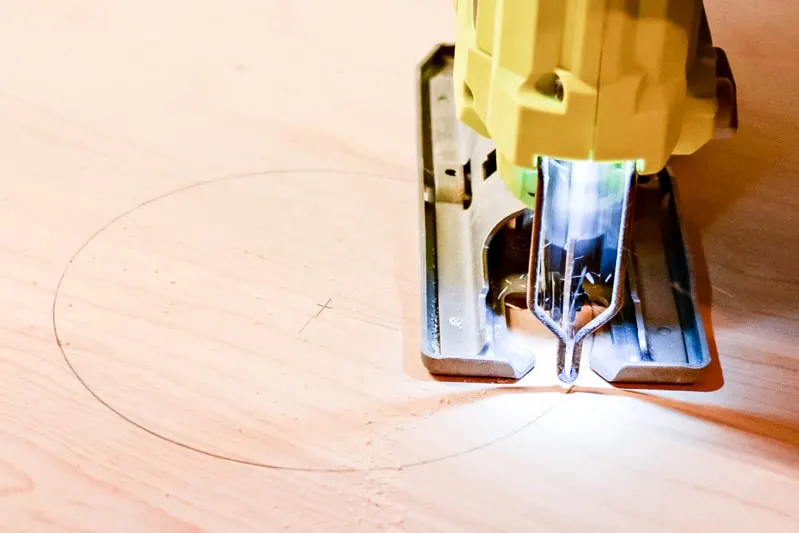 cutting a hole for the cornhole board with a jigsaw