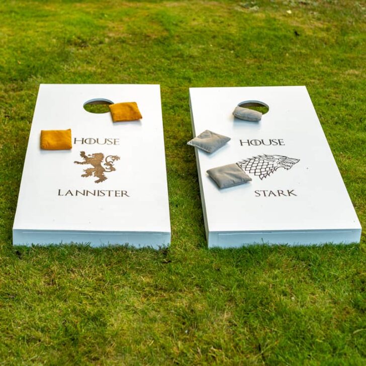 Game of Thrones themed DIY cornhole boards on grassy lawn