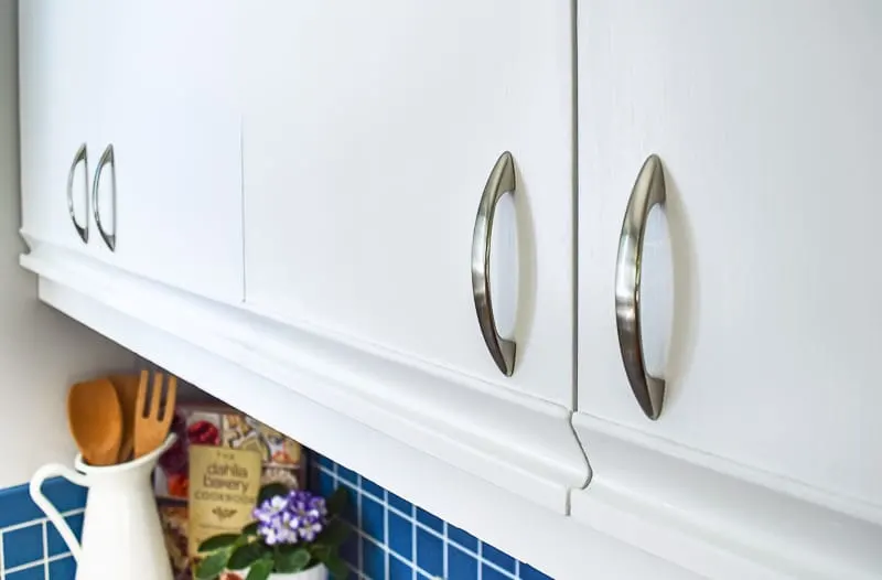painted melamine cabinets with oak grab bars with new hardware