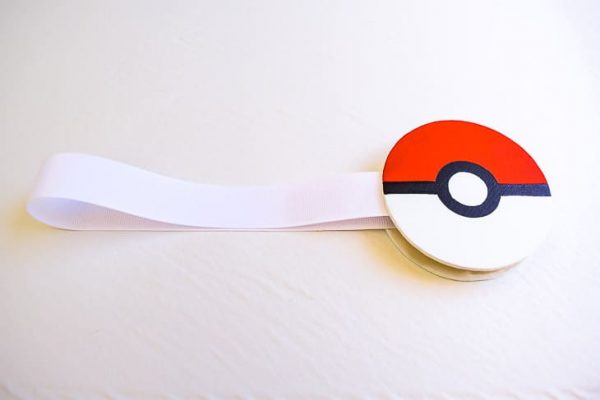 magnetic curtain tie back with white ribbon and pokeball