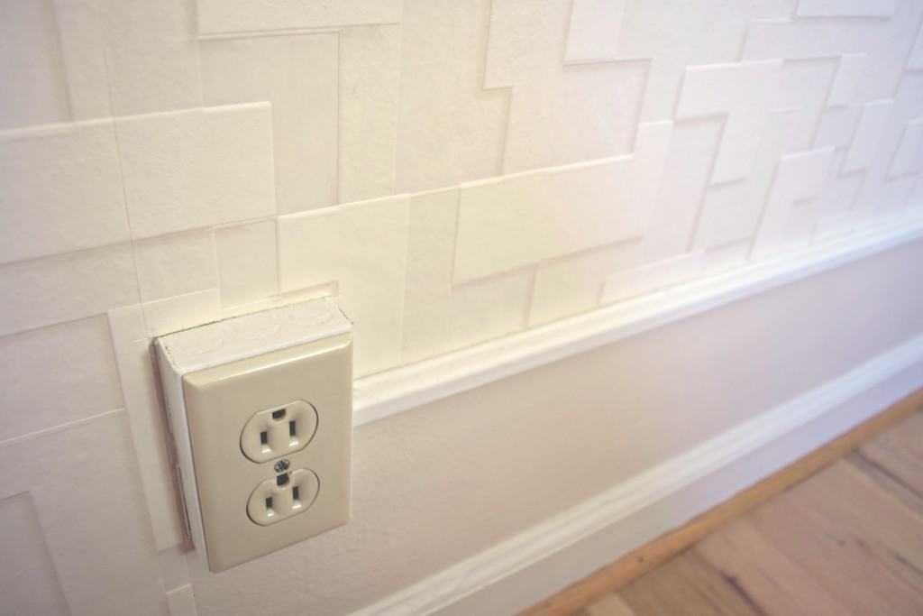 Rather than trying to match the wallpaper pattern below the electrical conduit, I just left that section painted. It won't be seen once the bed is in place. - The Handyman's Daughter