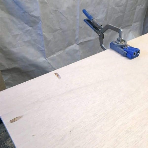drilling pocket holes along the perimeter of a sheet of plywood with the Kreg Jig R3