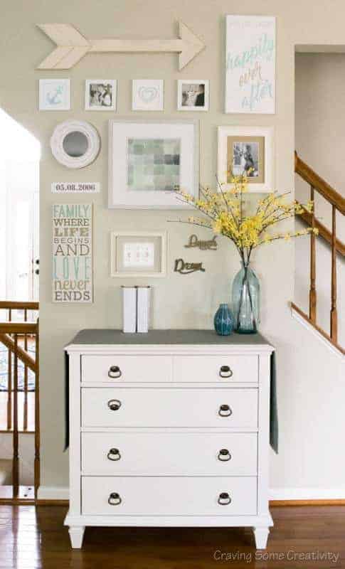 Incorporating arrow wall decor into a gallery wall breaks up blocky frames and gives it more appeal from across the room.