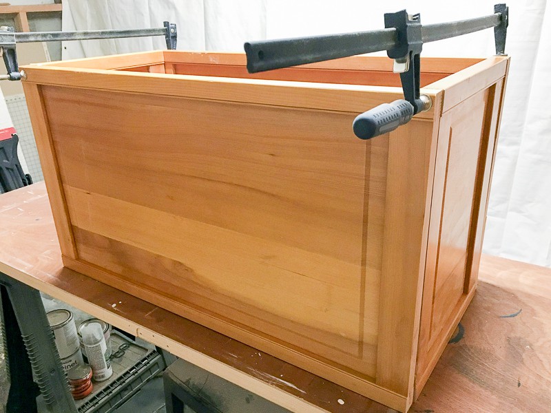 sides of blanket box held together with clamps