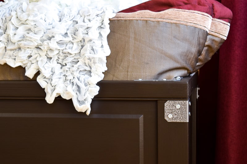 close up view of blanket box with decorative hardware