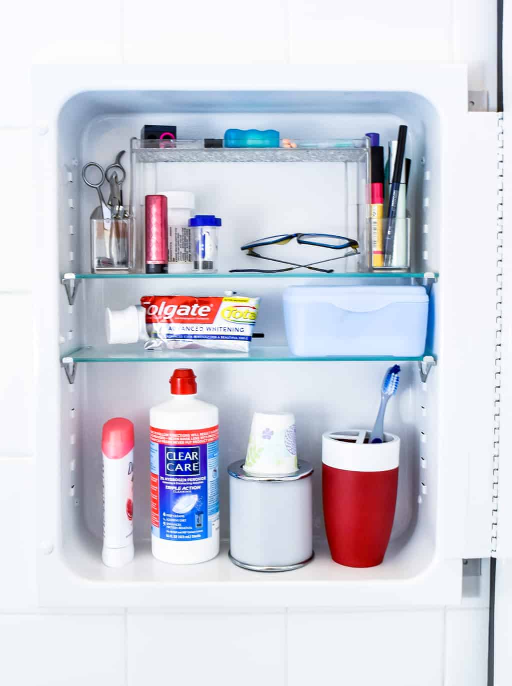 painted metal medicine cabinet with toiletries inside