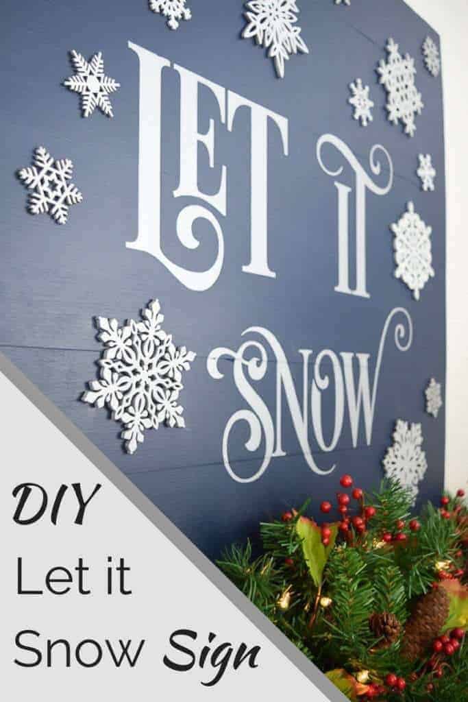 Wood Let it Snow sign with 3D snowflakes on fireplace mantle