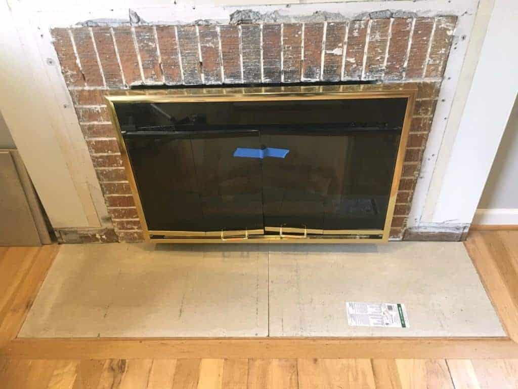 first layer of cement backer board in place in fireplace hearth