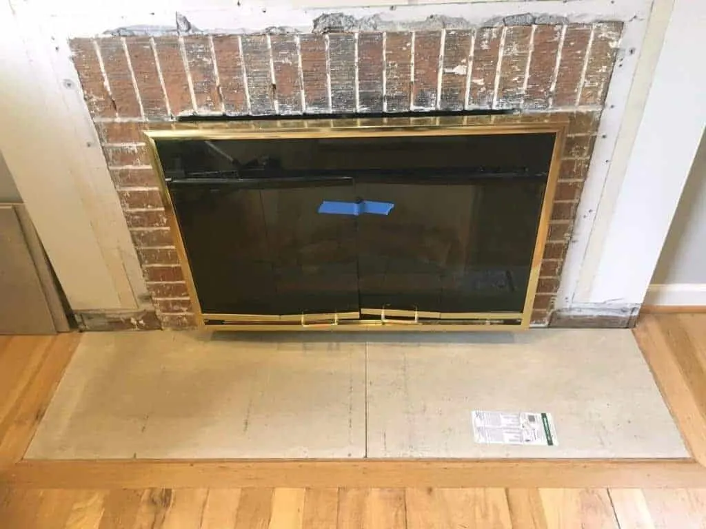 first layer of cement backer board in place in fireplace hearth