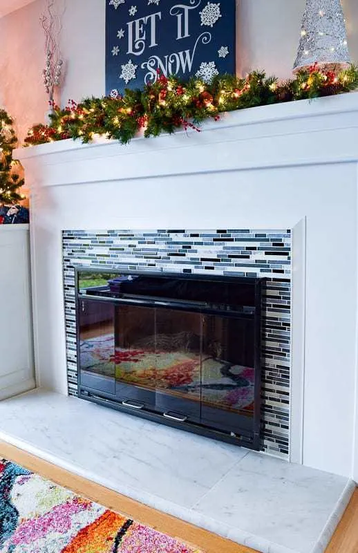 fireplace with Christmas decorations on mantle
