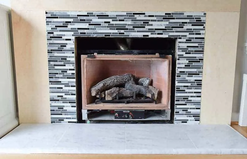 marble fireplace hearth tile and glass and stone tile around fireplace opening