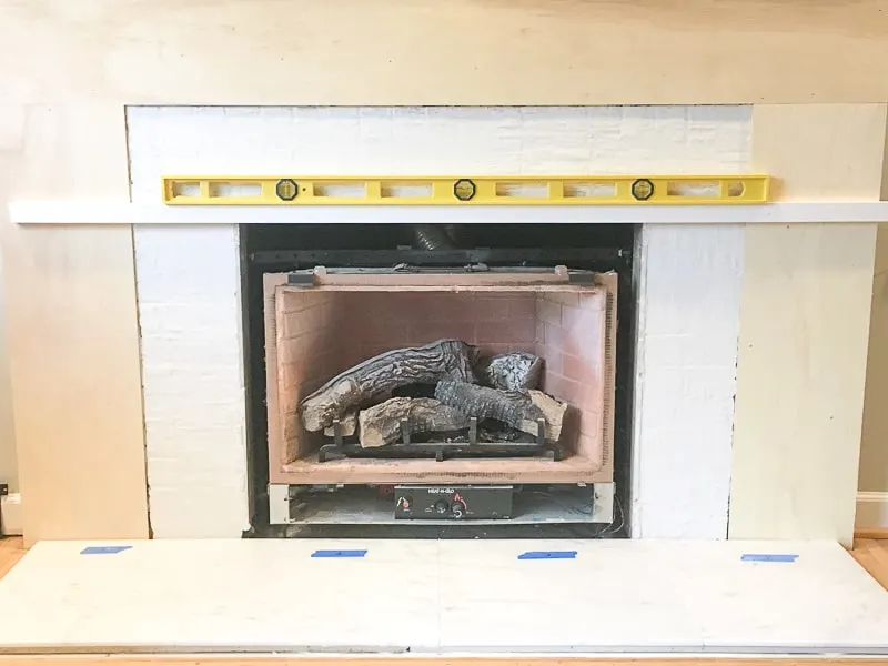 support board across firebox to support fireplace tile