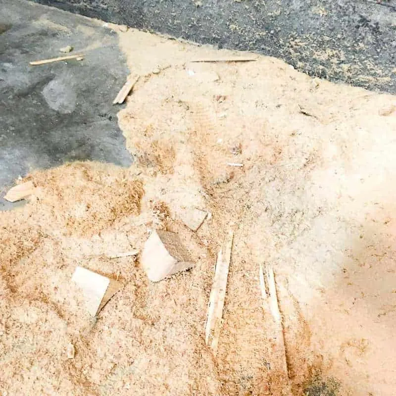 large pile of sawdust on concrete floor