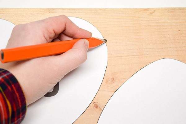 tracing heart template onto wooden board