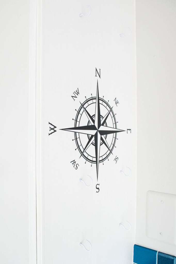 I drilled holes for the hooks into the side of the cabinet, then screwed the hooks in by hand.