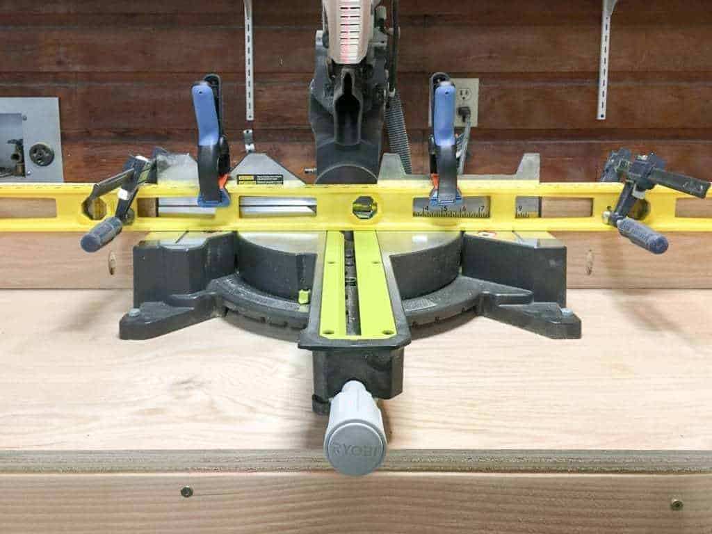 level across miter saw to align extension fences