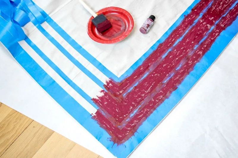 painting stripes on DIY rug with fabric paint