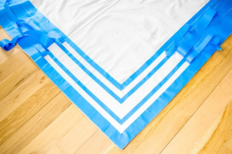 creating stripes on DIY rug with painter's tape