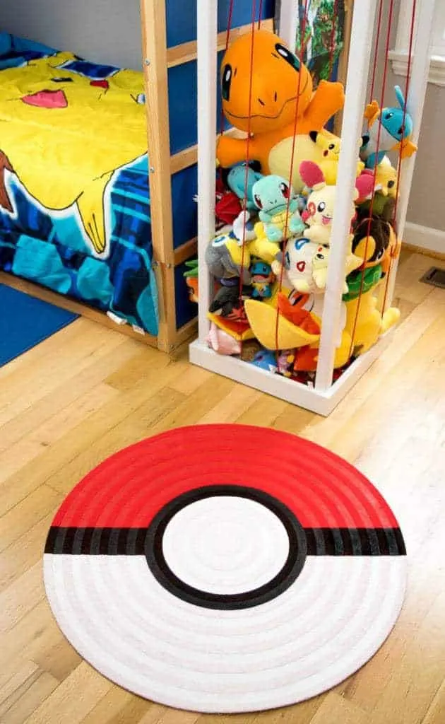 pokeball rug on hardwood floor next to stuffed animal zoo