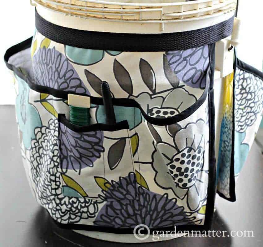 bucket with apron used as garden tool storage