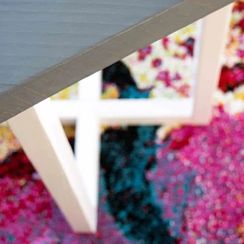 top down view of hexagon side table over colorful carpet