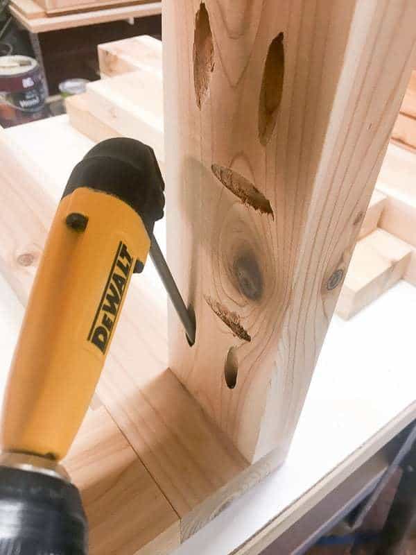 using a right angle attachment on a drill to access tight space between boards