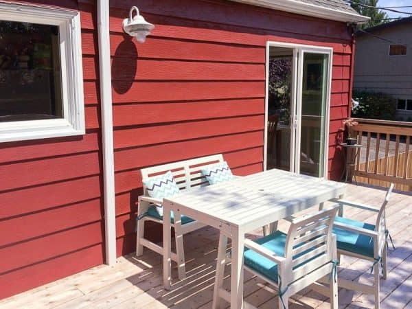 deck furniture on deck behind red house