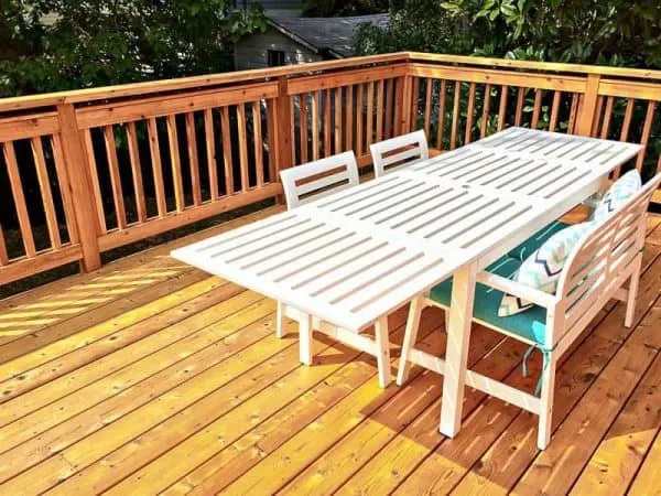white outdoor dining table on wooden deck