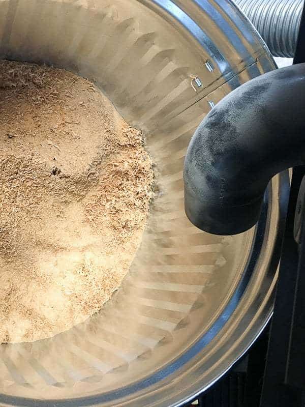 metal trash can full of sawdust