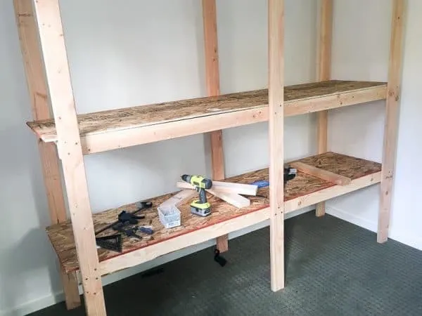 second shelf of shed shelving unit being assembled