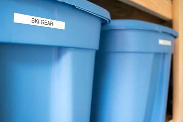 large plastic bins on shed shelving