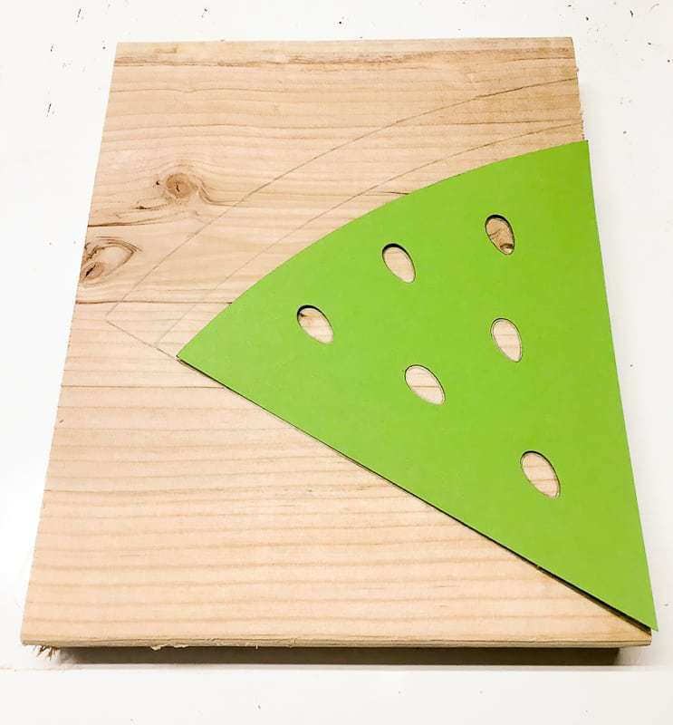 paper watermelon slice stencil on wooden board