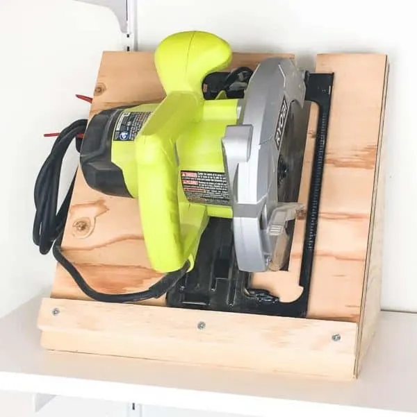 Tired of your circular saw sitting in a jumbled mess? This simple circular saw storage rack keeps it neatly stowed away until your next project inspiration strikes! | workshop storage | garage storage | easy woodworking project | tool storage