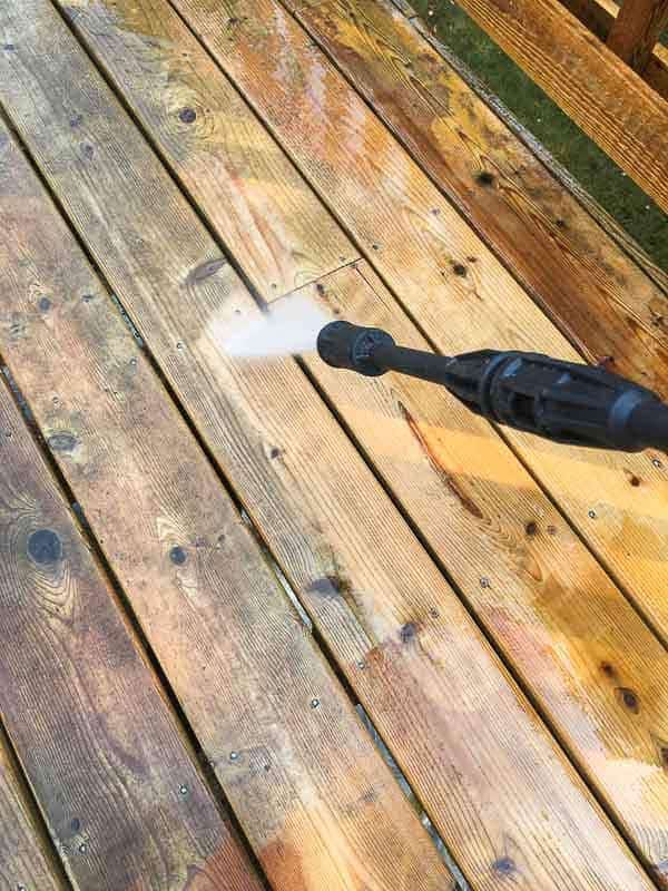 power washing deck cleaner off the surface