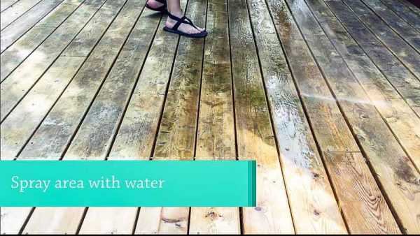 spraying deck with water before applying deck cleaner