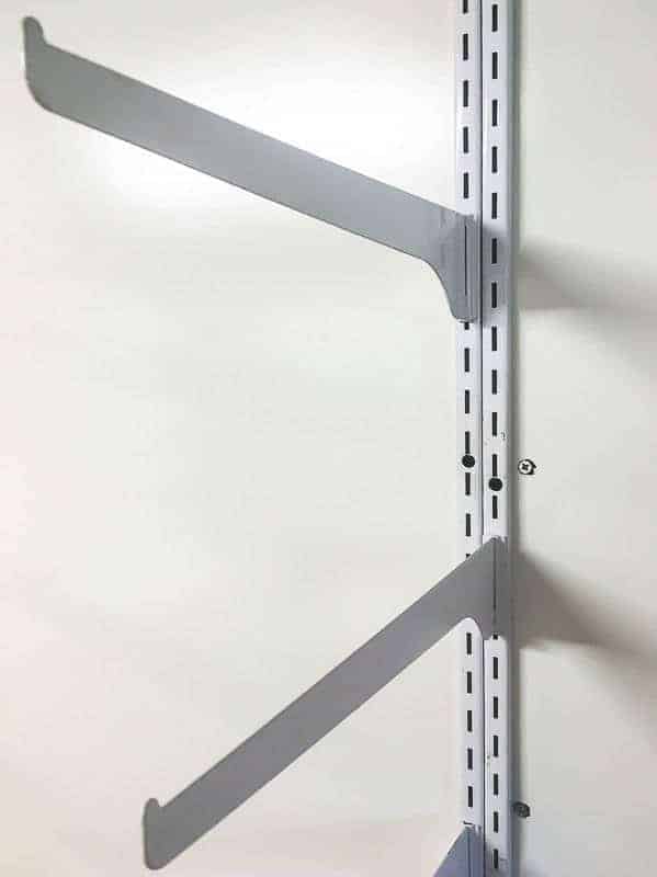 adjustable shelf brackets in between the arms of the lumber rack