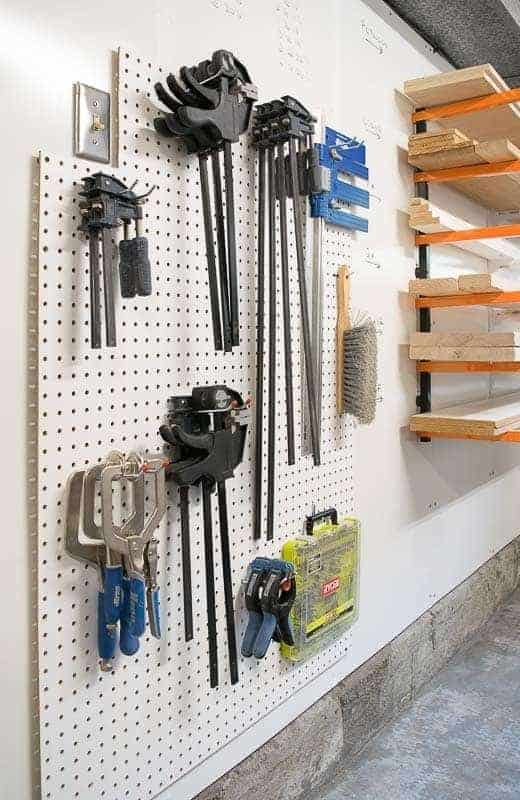 pegboard installed on whiteboard wall next to lumber rack