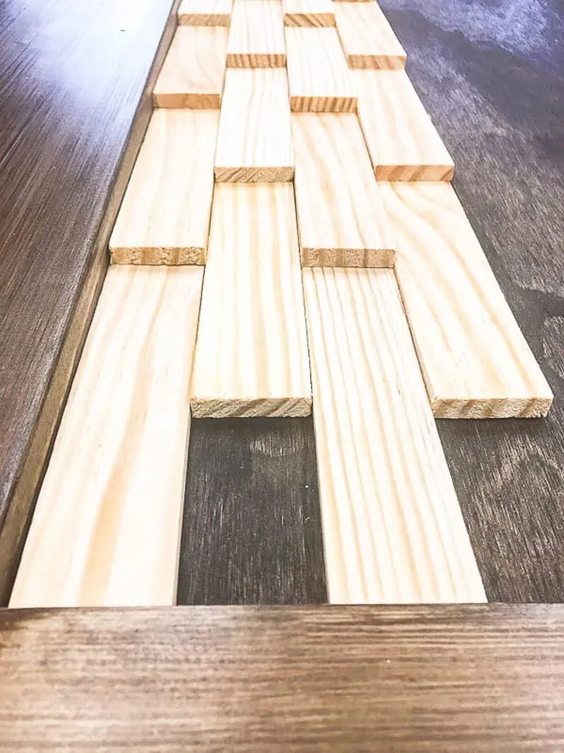 wood shims arranged vertically on a DIY barn door panel