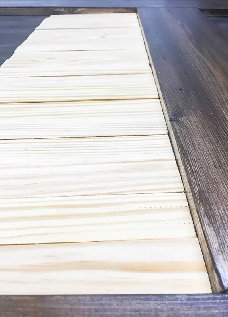 wood shims lined up at bottom of DIY barn door